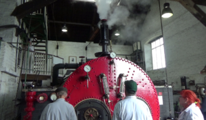 Boiler people standing by boiler in steam