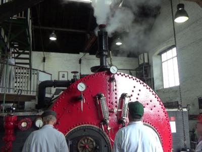 Boiler people standing by boiler in steam